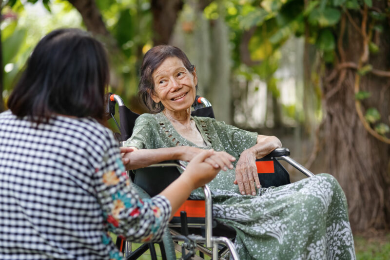 Elderly asian woman on wheelchair at home with daughter take care